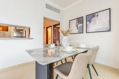 a dining room with a table and chairs at Spacious 1BR Overlooking City Skyline and Marina, Next to JLT Lakefront, Just Minutes to Metro, Jumairah Bay Tower X1, JLT by Deluxe Holiday Homes in Dubai