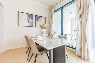 a dining room with a table and chairs at Spacious 1BR Overlooking City Skyline and Marina, Next to JLT Lakefront, Just Minutes to Metro, Jumairah Bay Tower X1, JLT by Deluxe Holiday Homes in Dubai
