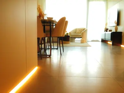 a living room with a table and chairs with a light on the floor at Burj Khalifa View Luxe 2BR x Connected to Dubai Mall in Dubai