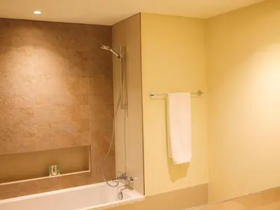 a bathroom with a shower and a tub and a sink at Burj Khalifa View Luxe 2BR x Connected to Dubai Mall in Dubai