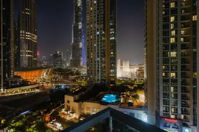 a view of a city at night with tall buildings at Iconic Views 2BR Burj Khalifa and Fountain in Dubai