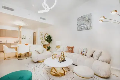 a living room with a white couch and a table at Iconic Views 2BR Burj Khalifa and Fountain in Dubai