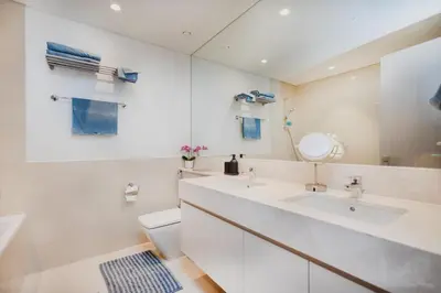a bathroom with a sink and a toilet and a mirror at Iconic Views 2BR Burj Khalifa and Fountain in Dubai