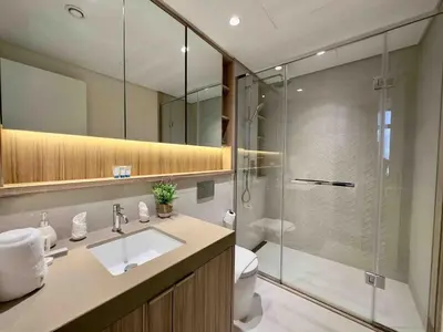 a bathroom with a shower and a sink and a toilet at Spacious & Modern 1BR in Wilton Terraces in Dubai
