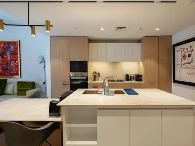 a kitchen with a sink and a counter top at Modern Neoclassical 1BR - Berkeley Place Dubai in Dubai