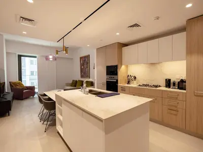 a kitchen with a large island in a room at Modern Neoclassical 1BR - Berkeley Place Dubai in Dubai