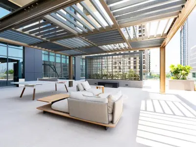 a living room with a couch and a table at Modern Neoclassical 1BR - Berkeley Place Dubai in Dubai