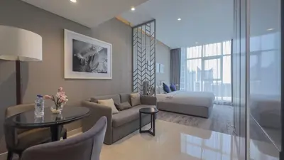 a living room with a couch and a table at Luxury Studio in Heart of Dubai in Dubai