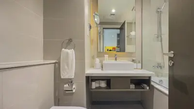 a bathroom with a sink and a toilet and a mirror at Luxury Studio in Heart of Dubai in Dubai