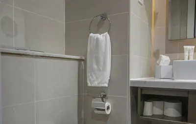 a bathroom with a white towel hanging on a wall at Luxury Studio in Heart of Dubai in Dubai