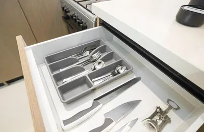 a drawer in a kitchen with silver utensils at A&S Properties Downtown Dubai in Dubai