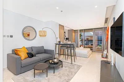 a living room with a couch and a table at Elegant Designer Studio8 Min Walk to Burj Khalifa in Dubai