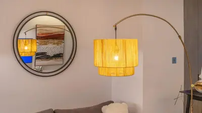 a living room with two lamps and a mirror at Elegant Designer Studio8 Min Walk to Burj Khalifa in Dubai