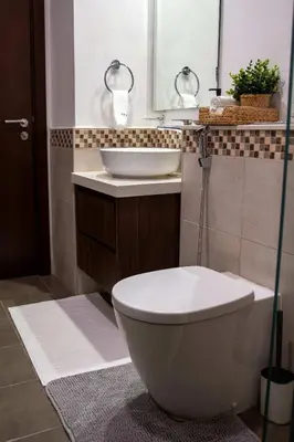 a bathroom with a white toilet and a sink at Cozy Burj Khalifa View Retreat in Dubai