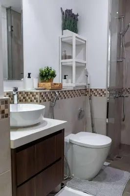 a bathroom with a toilet and a sink and a shower at Cozy Burj Khalifa View Retreat in Dubai