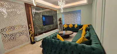 a living room with a green couch with yellow pillows at Homeeza Luxury 2BR Apartment Sea Views Dubai Marina in Dubai