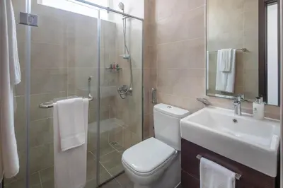 a bathroom with a shower and a toilet and a sink at Frank Porter - Avencia, Damac Hills 2 in Dubai