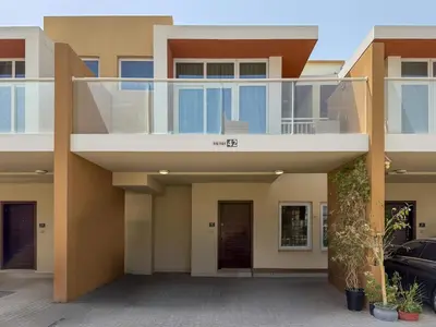 a house with a balcony and a car parked in front at Frank Porter - Avencia, Damac Hills 2 in Dubai