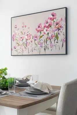 a dining room table with a picture on the wall at Frank Porter - Avencia, Damac Hills 2 in Dubai