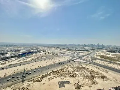 an aerial view of a highway with cars on it at Homes2Retreat - Golf & Desert Views - Luxe 1BR Escape in Dubai