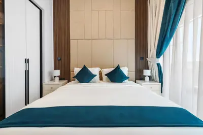 a bedroom with a large bed with blue pillows at ALiving Modern 1BR I Private Pool I Opalz by Danube- 1704 in Dubai