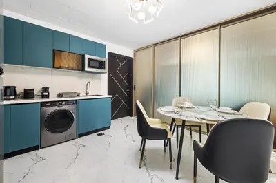 a kitchen and dining room with a table and chairs at ALiving Modern 1BR I Private Pool I Opalz by Danube- 1704 in Dubai