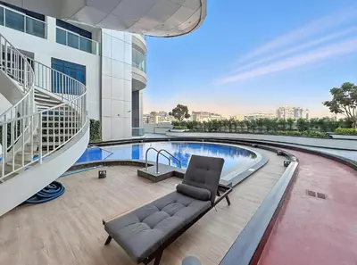 a couch in the middle of a building with a pool at ALiving Modern 1BR I Private Pool I Opalz by Danube- 1704 in Dubai