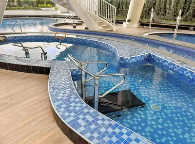 a large swimming pool with a blue tiled floor at ALiving Modern 1BR I Private Pool I Opalz by Danube- 1704 in Dubai