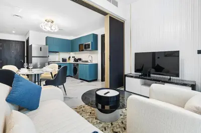 a living room with a couch and a table at ALiving Modern 1BR I Private Pool I Opalz by Danube- 1704 in Dubai