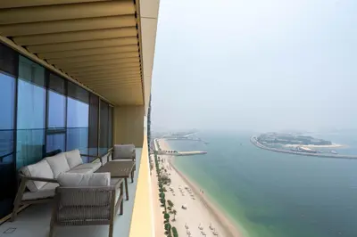 a balcony with chairs and a view of the ocean at KeyRock - Palm & Sea View Apt at Grand Bleu in Dubai