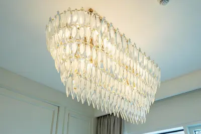 a large glass chandelier hanging from a ceiling at KeyRock - Palm & Sea View Apt at Grand Bleu in Dubai
