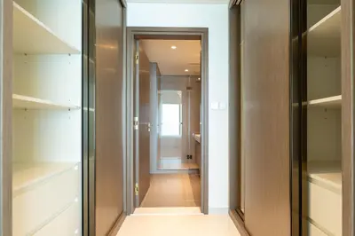 a walk in closet with glass doors and a hallway at KeyRock - Palm & Sea View Apt at Grand Bleu in Dubai
