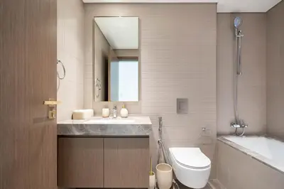 a bathroom with a sink and a toilet and a tub at KeyRock - Palm & Sea View Apt at Grand Bleu in Dubai