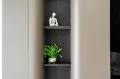 a book shelf with a plant on it at KeyRock - 1BR with Sea & Palm Jumeirah Views in Dubai