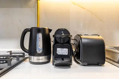 a coffee maker and a toaster sitting on a counter at ALiving Modern Studio I Private Pool I Opalz by Danube- 1308 in Dubai