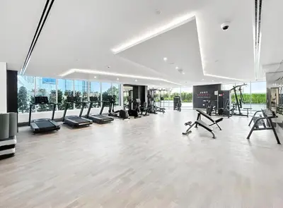 a gym with treadmills and exercise equipment in a building at ALiving Modern Studio I Private Pool I Opalz by Danube- 1308 in Dubai