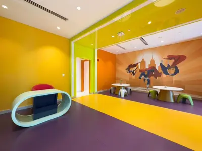 a brightly colored room with two tables and chairs at GuestReady - Canal View | Studio + Sofa Bed in Dubai