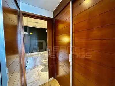 a wooden door in a building with a reflection in a window at Kempinski Central Avenue Studio Burj view in Dubai