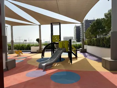 a playground with a slide in a building at ASHRI HH Condo In Riviera Meydan in Dubai