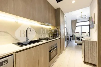 a kitchen with a sink and a stove at Bloomfields Stylish Stu Laya Heights in Dubai