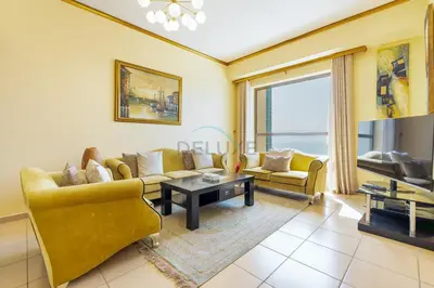 a living room with a couch and a table at Ain Dubai & Sea Views 2BR Unit Close to Beach, Shams 4, Jumeirah Beach Residence by Deluxe Holiday Homes in Dubai