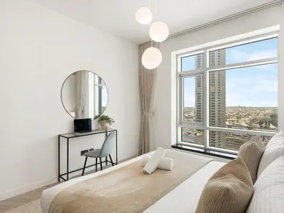 a living room with a large window and a mirror at Kensington Stylish 1BR at The Lofts East Downtown in Dubai