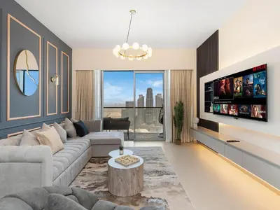 a living room with a couch and a tv at Grande Signature Premium Stay in Dubai