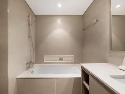 a bathroom with a bath tub and a sink at Grande Signature Premium Stay in Dubai