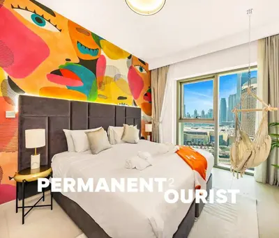 a bedroom with a bed with a painting on the wall at Stunning 2BR Dubai Mall Pool Gym Burj Khalifa in Dubai