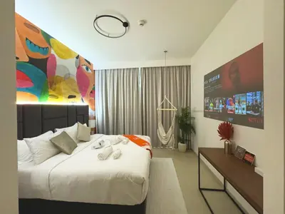 a bedroom with a large white bed and a large painting at Stunning 2BR Dubai Mall Pool Gym Burj Khalifa in Dubai