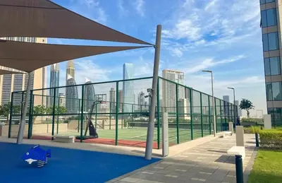 a view of a city skyline from a tennis court at Stunning 2BR Dubai Mall Pool Gym Burj Khalifa in Dubai
