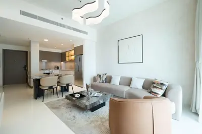 a living room with a couch and a table at KeyRock - Stylish 2BR Apt with Palm Jumeirah View, Balcony , Pool & Gym Access in Dubai