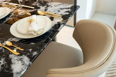 a dining room table with a plate and two chairs at KeyRock - Stylish 2BR Apt with Palm Jumeirah View, Balcony , Pool & Gym Access in Dubai