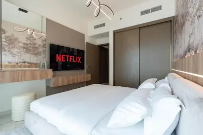 a bedroom with a large bed with white pillows at KeyRock - Stylish 2BR Apt with Palm Jumeirah View, Balcony , Pool & Gym Access in Dubai